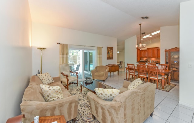 living room featuring vaulted ceiling, light tile patterned flooring, and visible vents