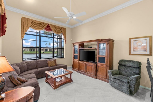 living area featuring baseboards, a ceiling fan, and crown molding