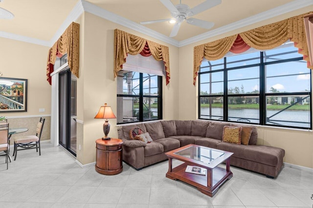 living area with ornamental molding, light tile patterned floors, and a ceiling fan