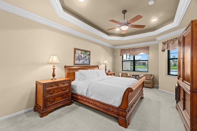 bedroom featuring light carpet, crown molding, a raised ceiling, and baseboards