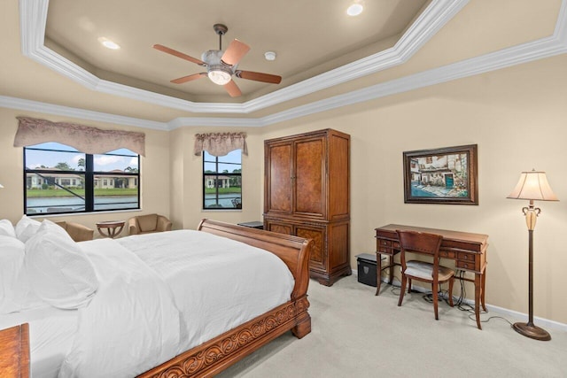 bedroom with crown molding, a raised ceiling, and light colored carpet