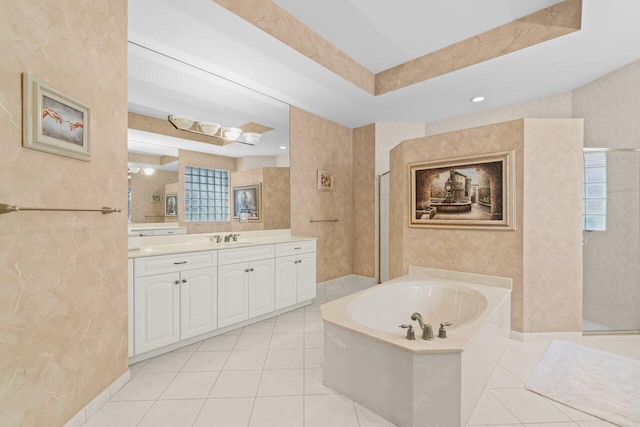 full bath with a garden tub, tile patterned flooring, a tray ceiling, vanity, and a walk in shower