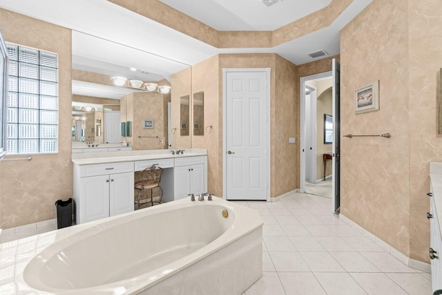 bathroom with a garden tub, visible vents, vanity, and tile patterned floors