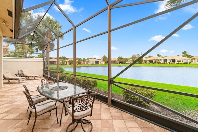 unfurnished sunroom with a water view and a residential view