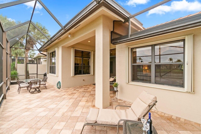 view of patio with glass enclosure