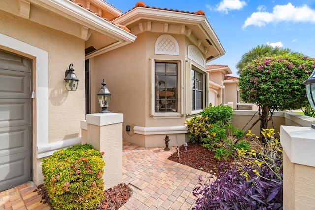 property entrance featuring stucco siding