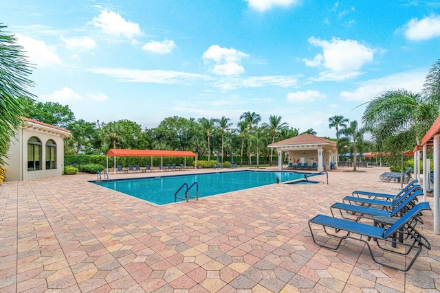 pool with a patio and fence