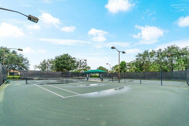 view of sport court featuring fence