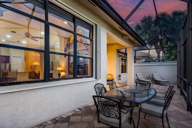 view of patio featuring a lanai