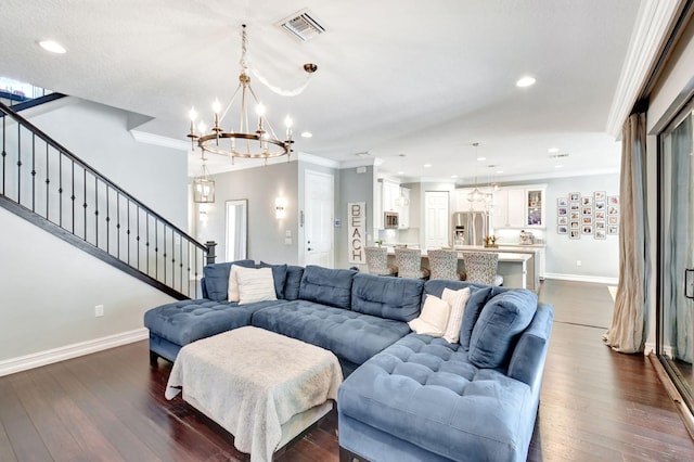 living area featuring stairway, visible vents, dark wood finished floors, and ornamental molding