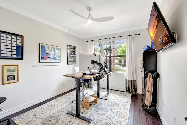 workout area featuring a ceiling fan, baseboards, dark wood-type flooring, and crown molding