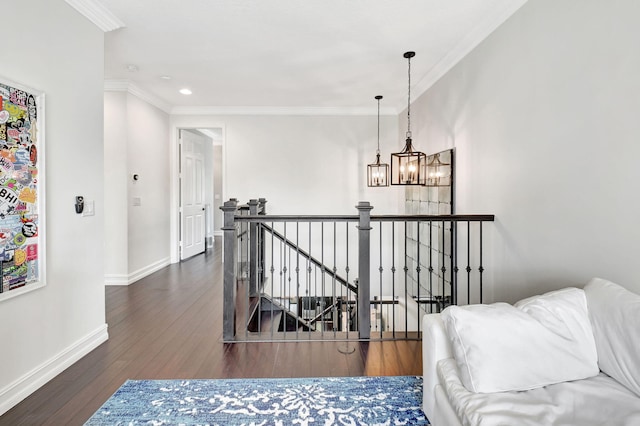 interior space with crown molding, an inviting chandelier, an upstairs landing, wood finished floors, and baseboards