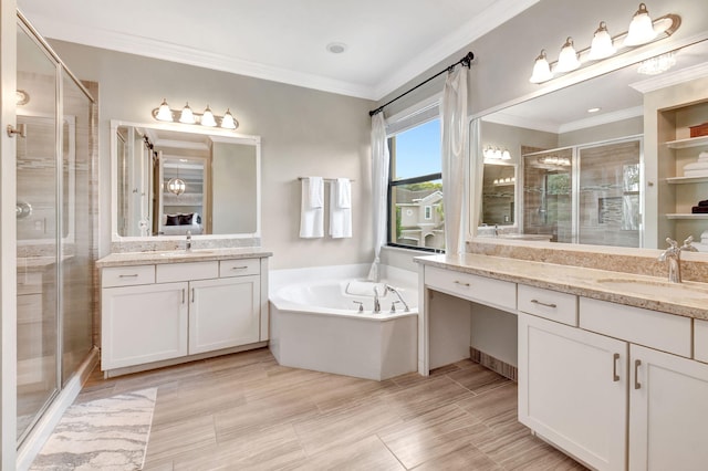 full bath featuring two vanities, ornamental molding, a stall shower, a sink, and a bath