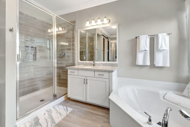 bathroom with a stall shower, ornamental molding, and a garden tub