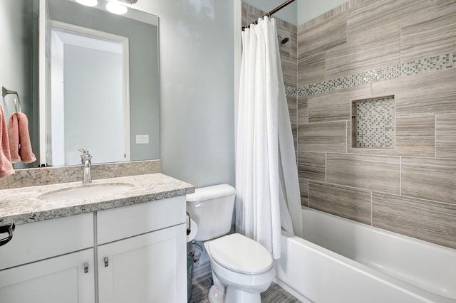 bathroom featuring shower / tub combo, vanity, and toilet