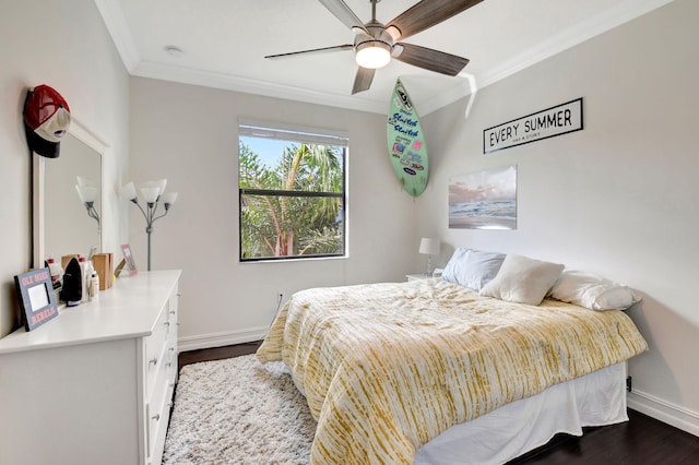 bedroom featuring ornamental molding, dark wood finished floors, and baseboards