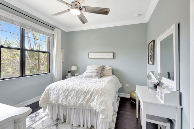 bedroom featuring ceiling fan, crown molding, baseboards, and wood finished floors