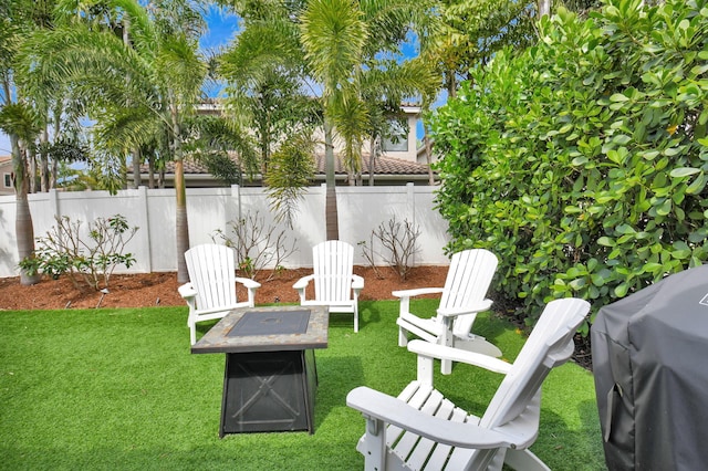 view of yard featuring an outdoor fire pit and fence