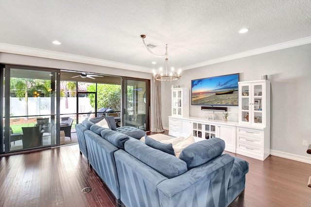 living room featuring baseboards, ornamental molding, dark wood finished floors, and a textured ceiling