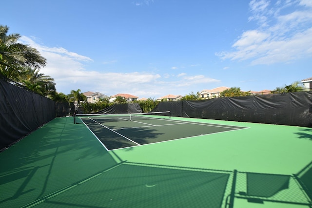 view of tennis court with fence