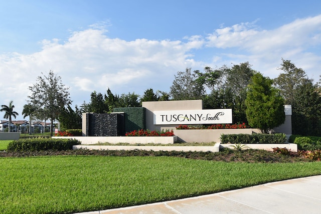 community / neighborhood sign with a lawn