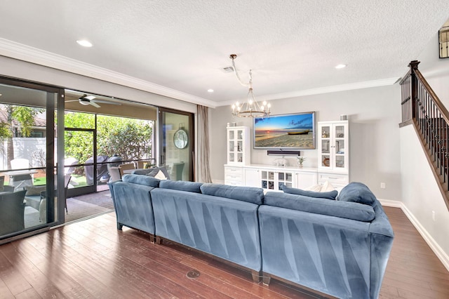 living room with baseboards, dark wood-style floors, stairs, crown molding, and a notable chandelier