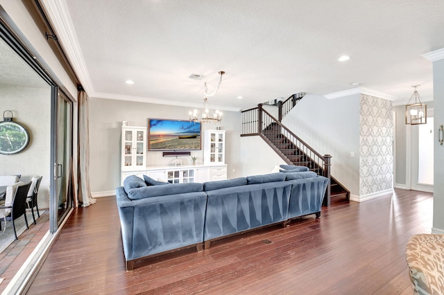 living room with ornamental molding, stairway, and an inviting chandelier