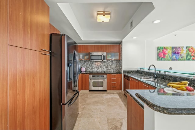 kitchen with a sink, modern cabinets, brown cabinetry, and stainless steel appliances