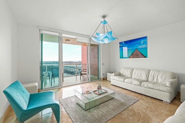 living room with baseboards and expansive windows