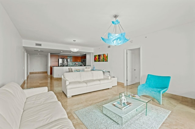 living room with visible vents and baseboards