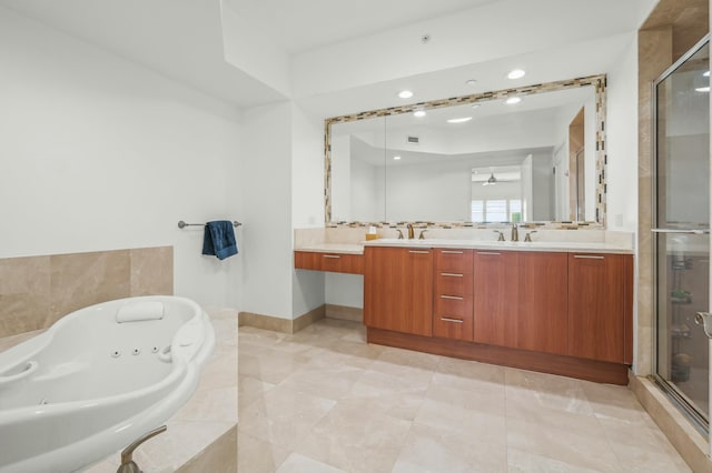 bathroom featuring double vanity, a tub with jets, a shower stall, and a sink