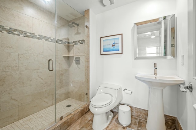 bathroom featuring toilet and a stall shower