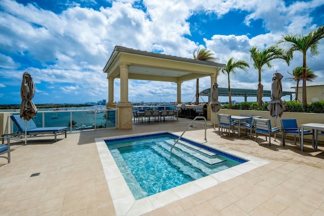 view of pool with a gazebo, outdoor dining area, and a patio