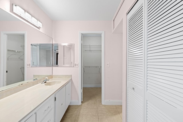 full bathroom featuring tile patterned floors, vanity, and baseboards