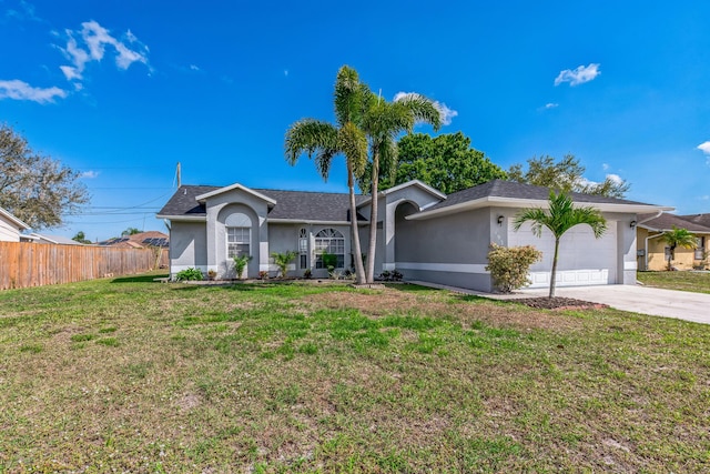 ranch-style home featuring a front lawn, an attached garage, fence, and stucco siding