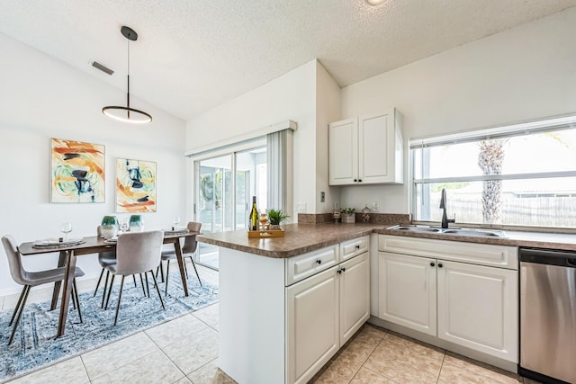 kitchen with lofted ceiling, a peninsula, a sink, visible vents, and stainless steel dishwasher