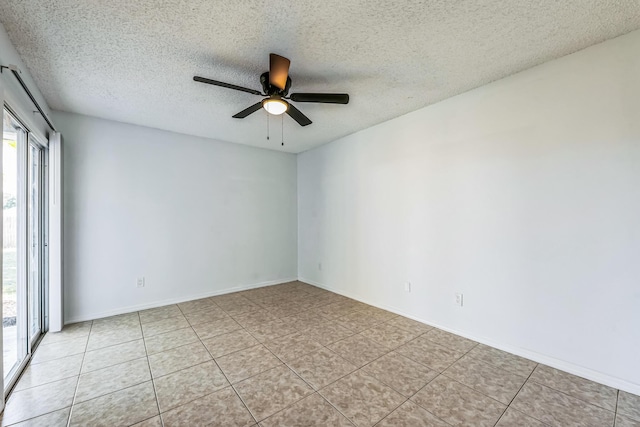 unfurnished room featuring ceiling fan, a textured ceiling, baseboards, and light tile patterned floors