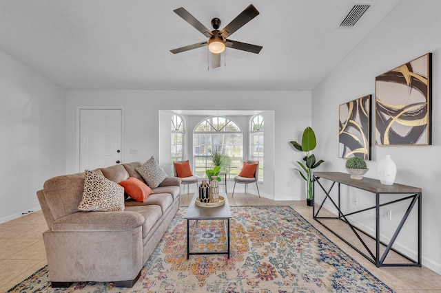 tiled living area with ceiling fan, visible vents, and baseboards