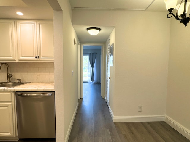 interior space featuring dark wood-type flooring, a sink, and baseboards