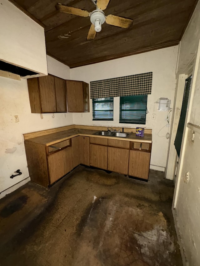 kitchen featuring ceiling fan, brown cabinetry, and a sink