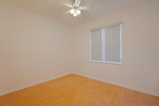 spare room with light wood-style floors, baseboards, and a ceiling fan