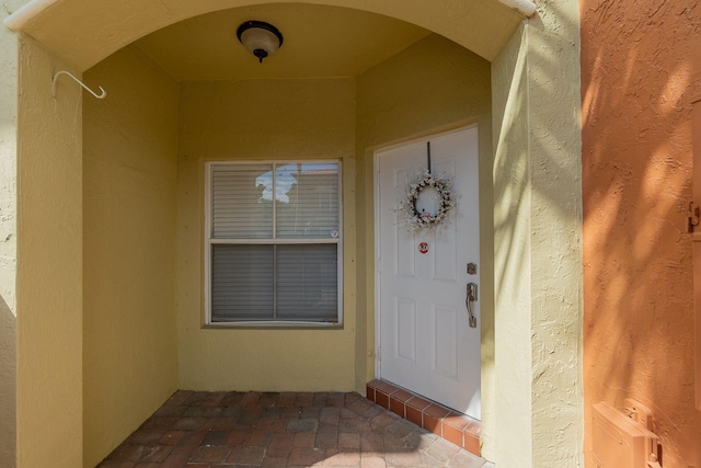 doorway to property with stucco siding