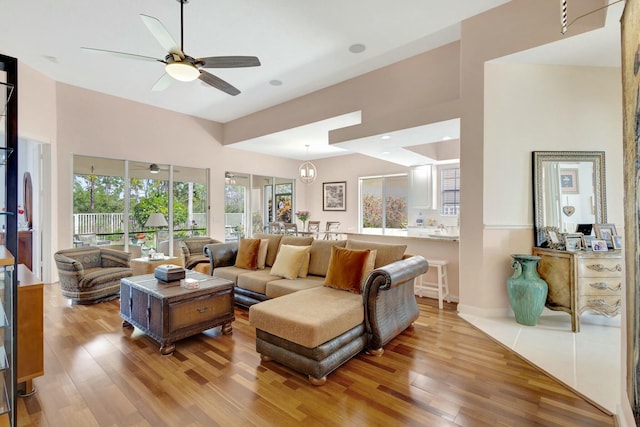 living room featuring a ceiling fan and wood finished floors