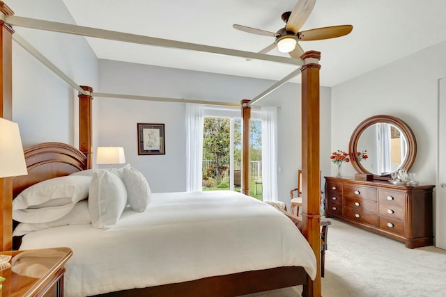 bedroom featuring light carpet, a ceiling fan, and decorative columns