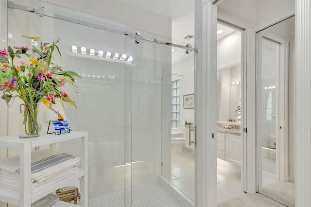 full bath featuring vanity, a shower stall, toilet, and tile patterned floors