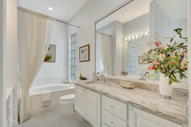 bathroom featuring tile patterned flooring, toilet, a bath, and vanity