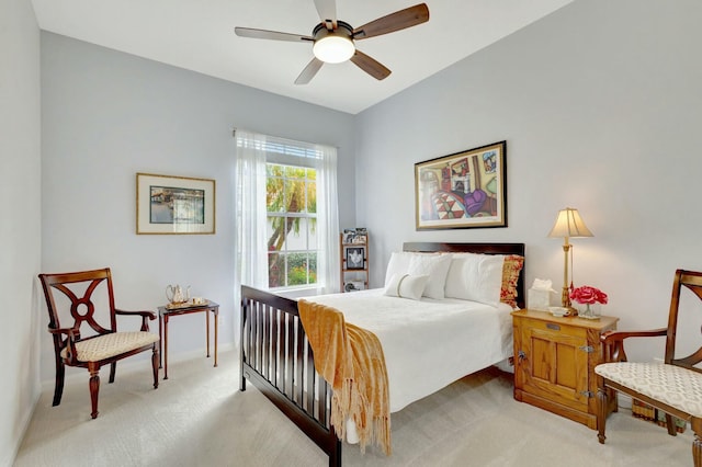 bedroom with a ceiling fan, baseboards, and light carpet