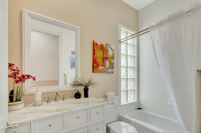 full bathroom with vanity, toilet, a wealth of natural light, and shower / washtub combination