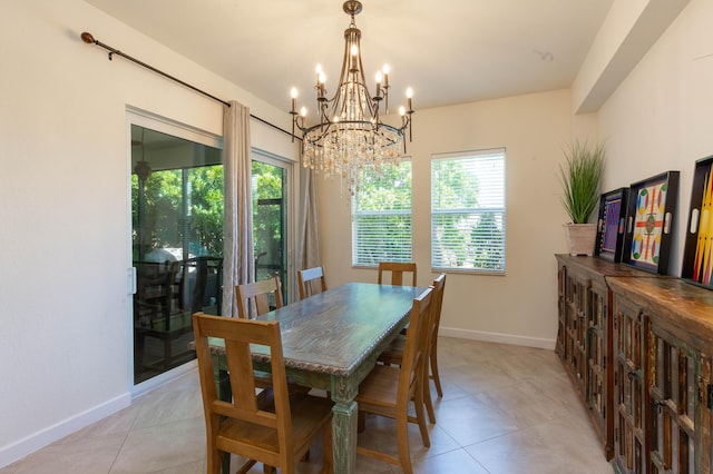 dining room featuring light tile patterned floors, a notable chandelier, and baseboards