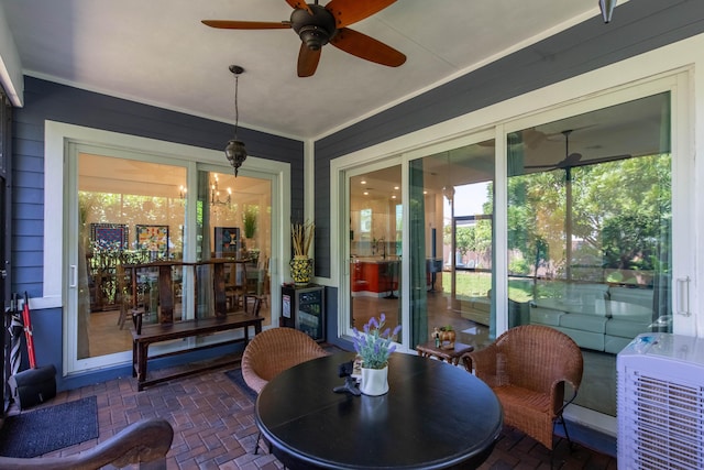 sunroom with a ceiling fan and wine cooler